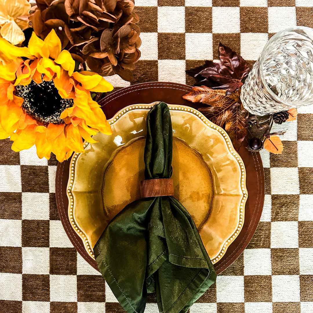 checkerboard tablecloth with a sunflower arrangement and a yellow plate