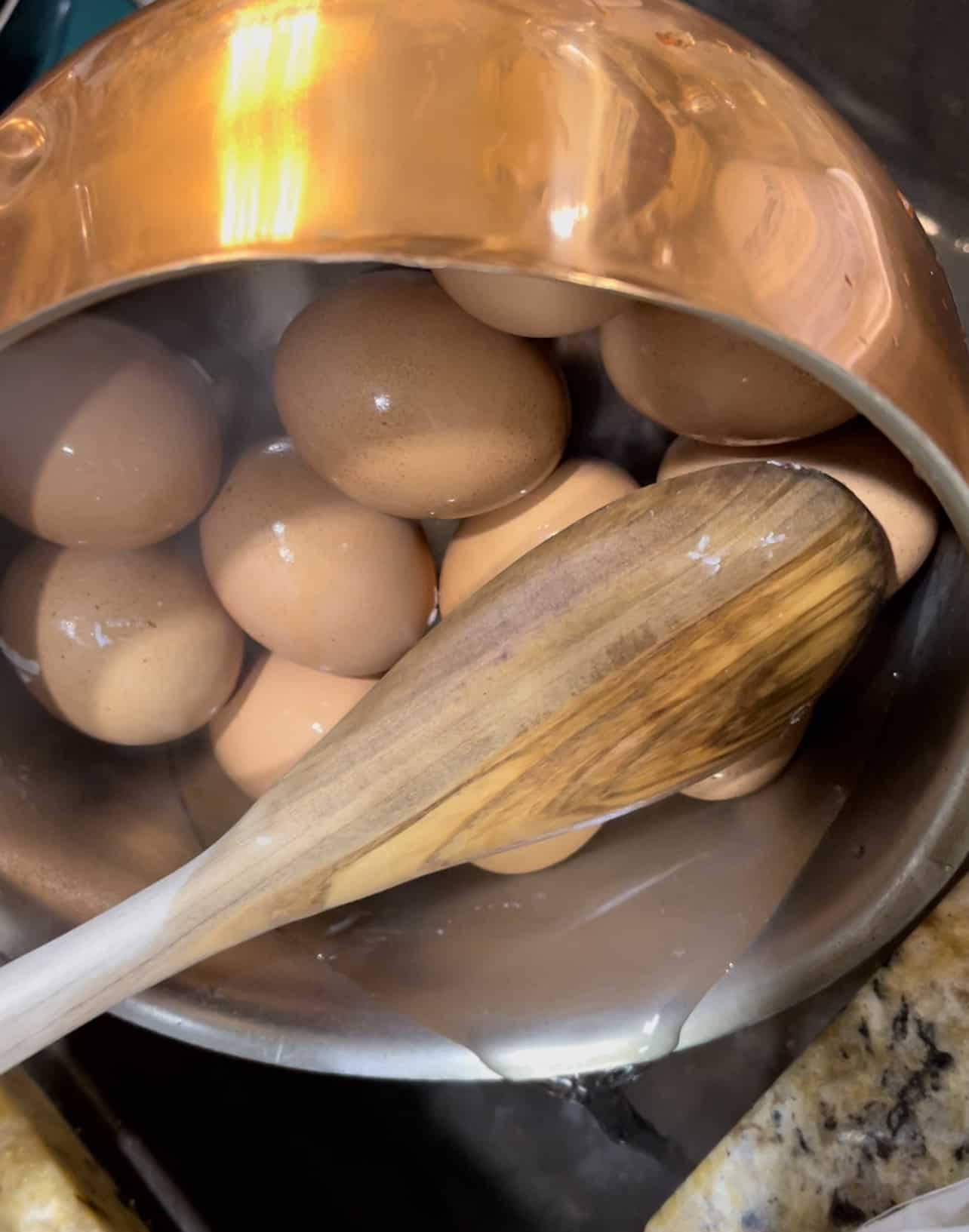 draining boiling water from boiled eggs