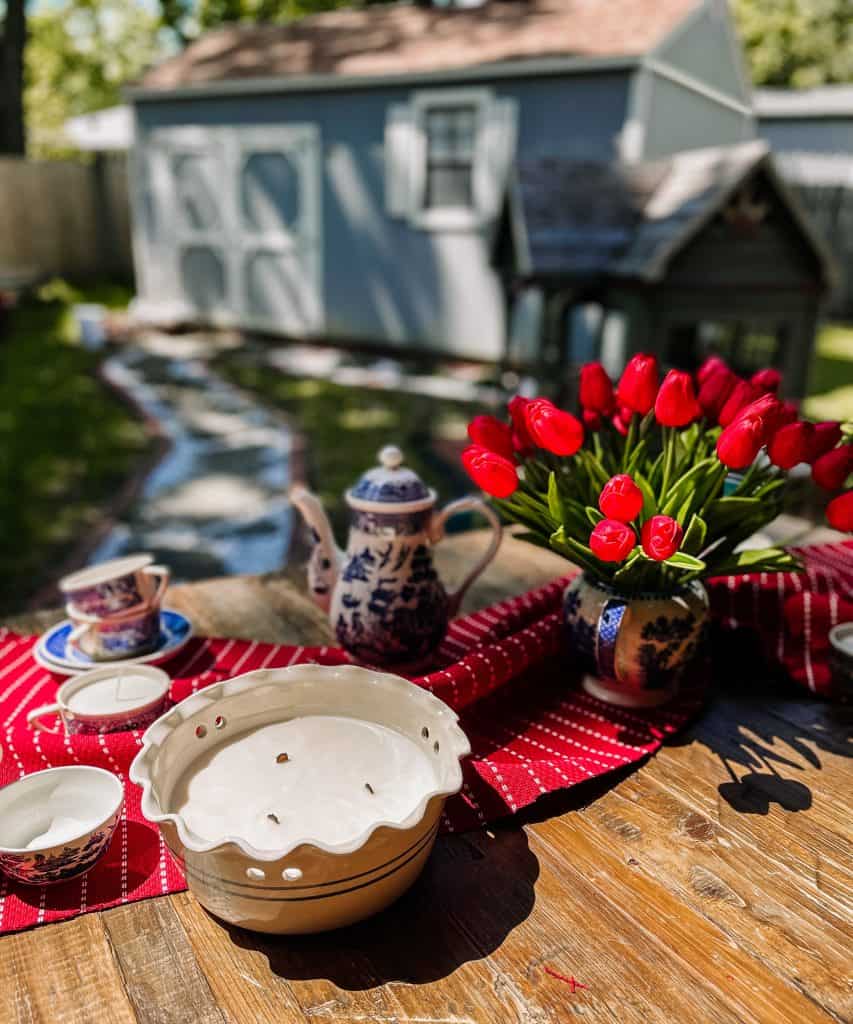 European style walkway to the backyard sheshed with table of tulips and citronella candle