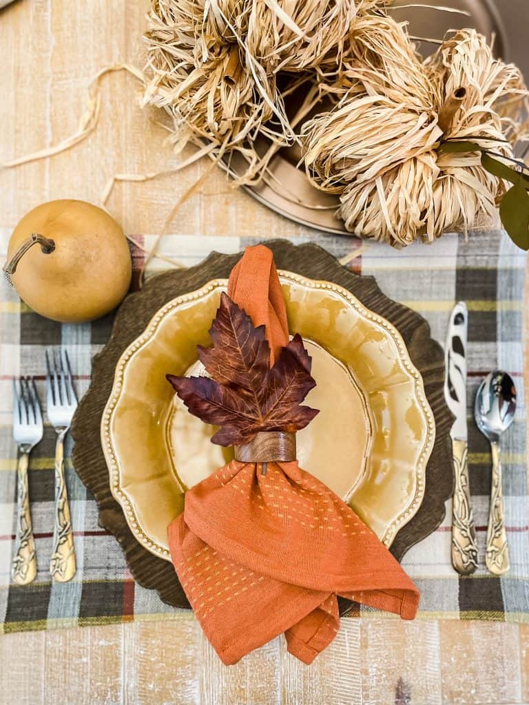 fall table setting with plaid, orange and gold