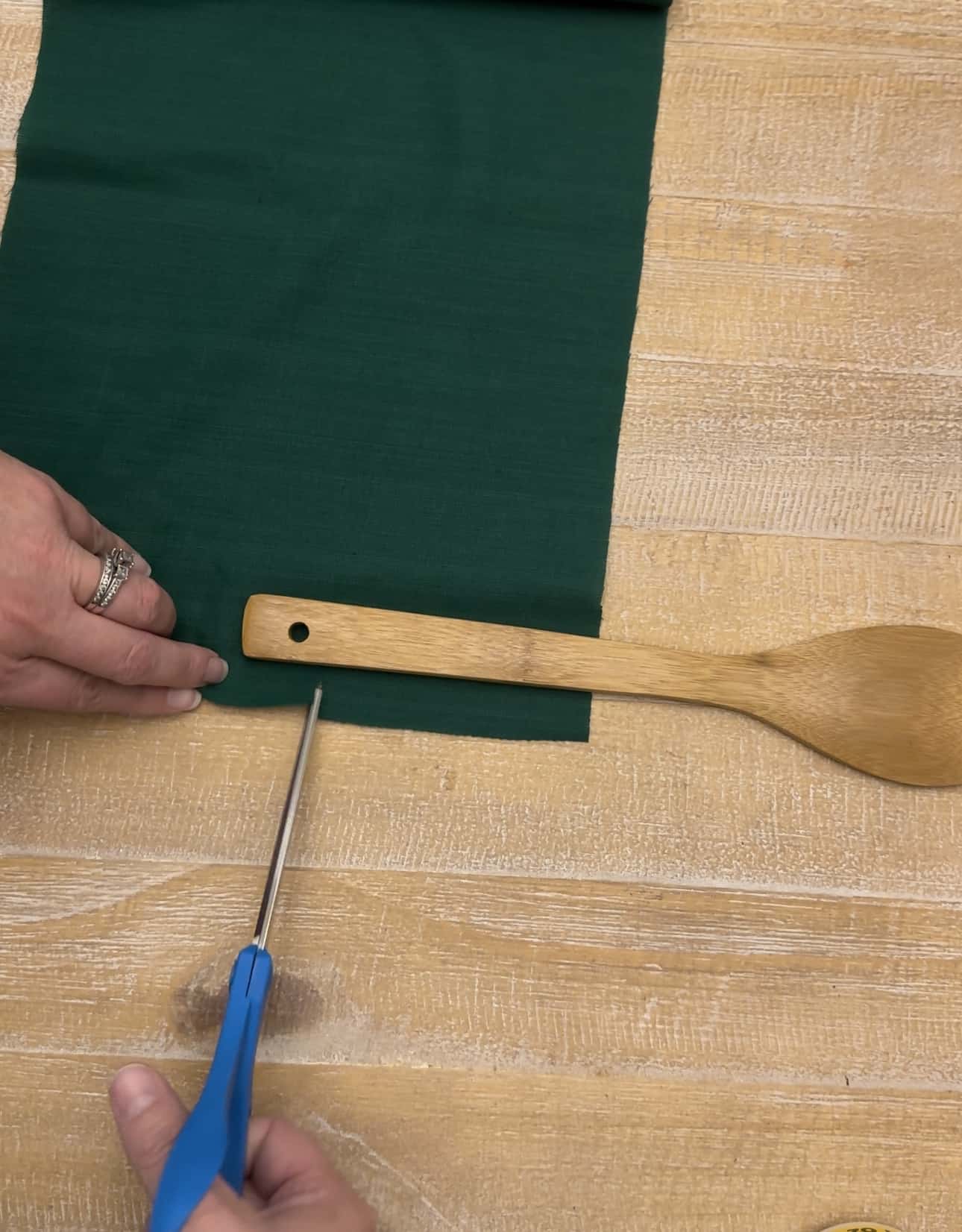 cutting green fabric for wooden spoons