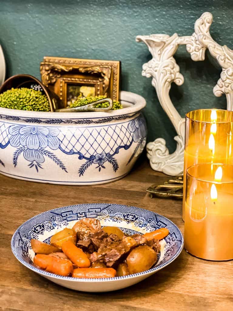 My Beef Bourguignon Instant Pot recipe in a blue and white china dish with an elegant setting. 