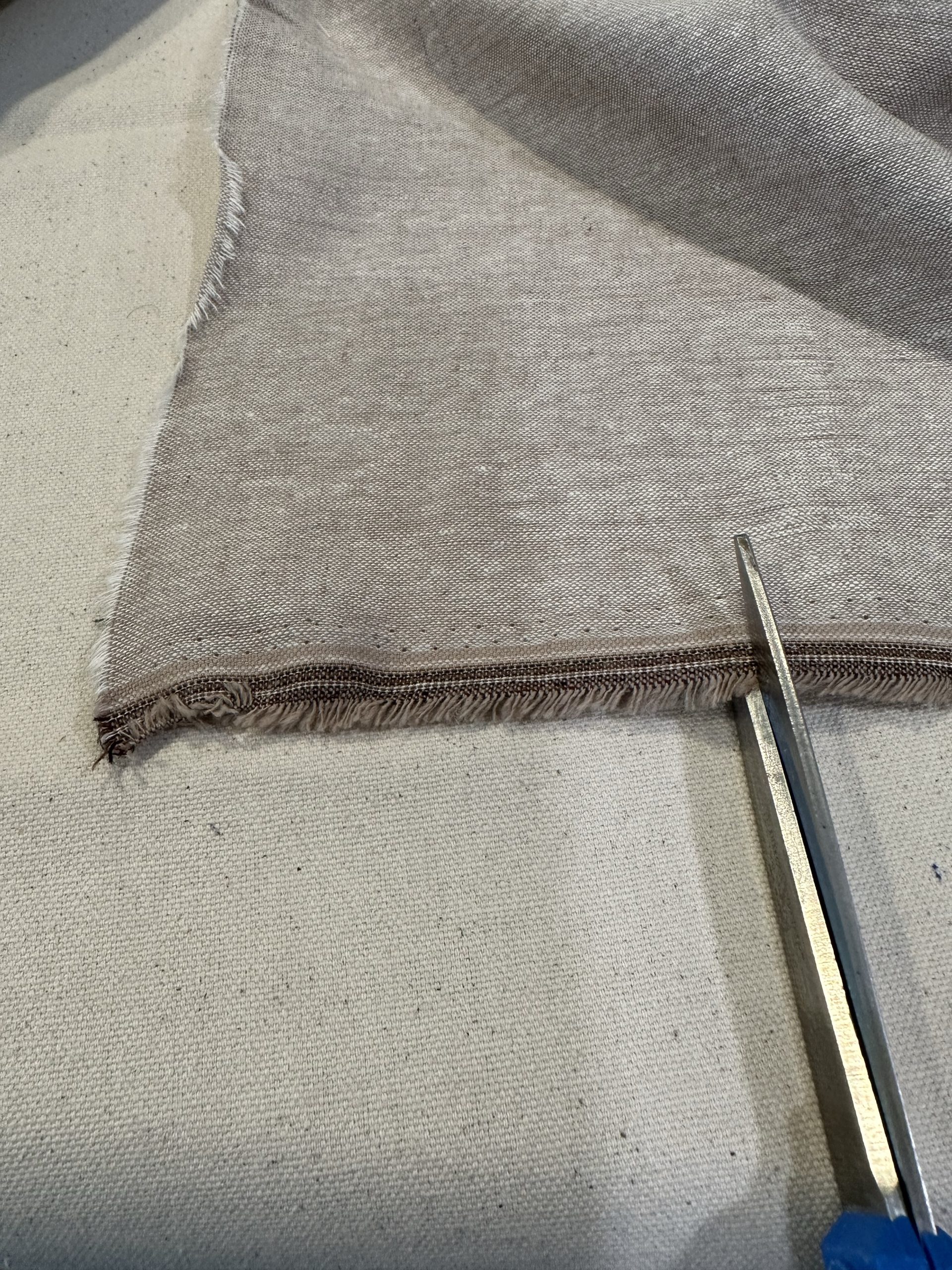 tearing linen fabric for a bookmark
