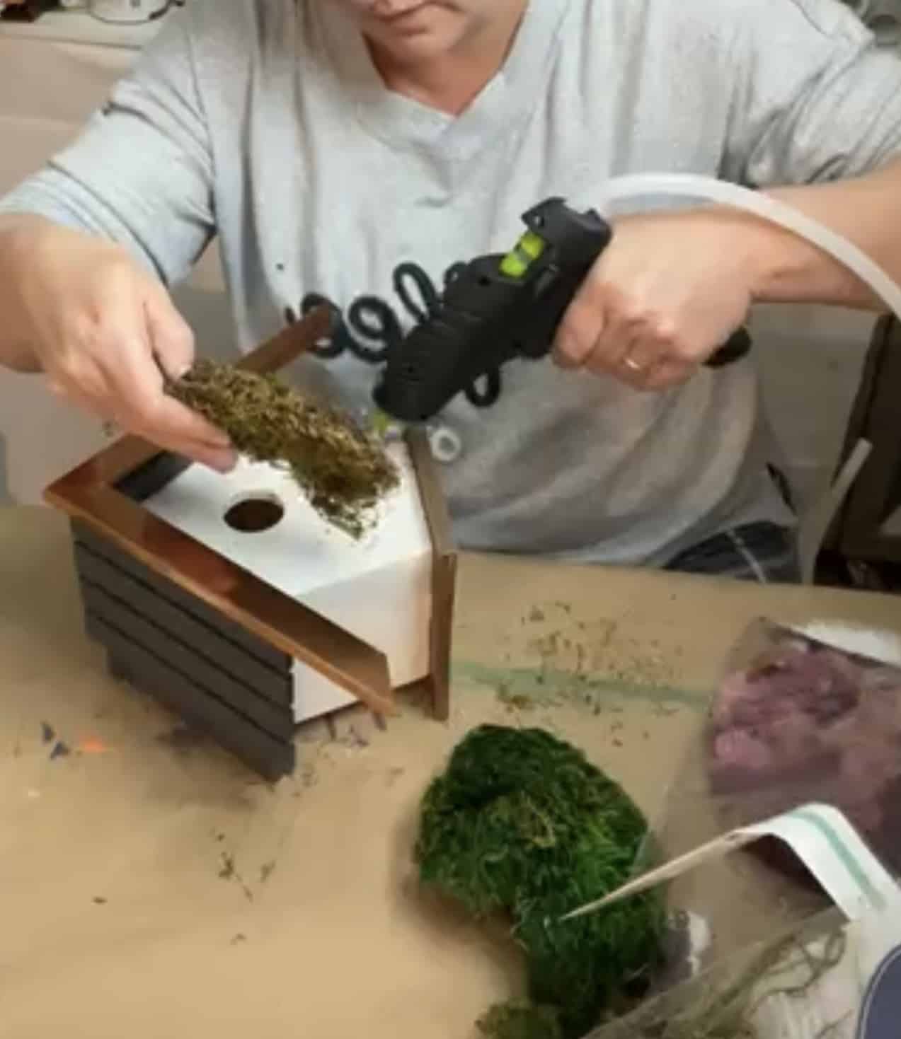 hot glue and moss on a spring birdhouse