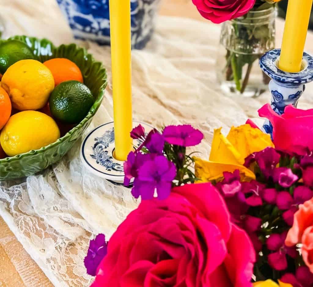 Roses set on an easy european farmhouse tablescape with oranges, lemons and limes