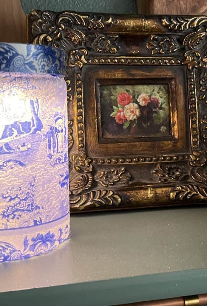 Chinoiserie lantern beside a gilded floral oil painting